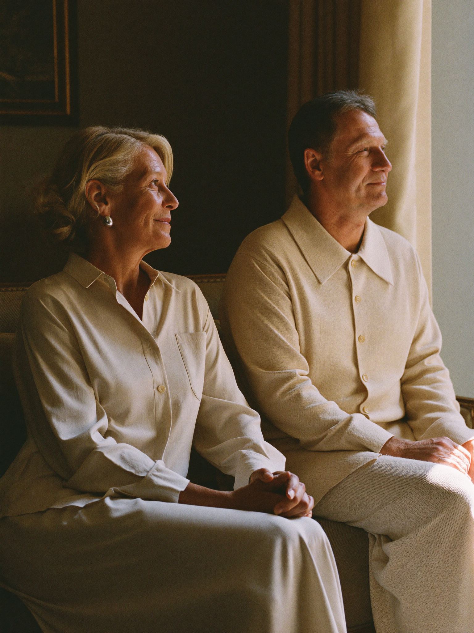 A retired couple at ease at home in warm light